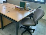 a desk with a chair and a laptop on it