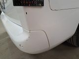 a close up of a white car with a license plate on it