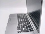 a silver laptop computer sitting on top of a white table
