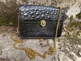 black leather purse with gold chain and chain strap