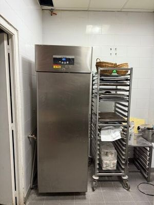 a large stainless steel refrigerator in a kitchen with a lot of shelves