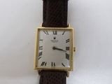 a close up of a wrist watch with roman numerals on it