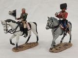 two figurines of soldiers riding horses on a snowy surface
