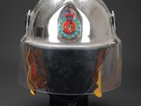 a close up of a helmet on a stand on a black background
