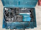 a blue tool box with tools in it on the floor