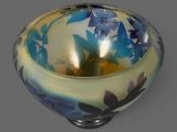 a blue and yellow bowl sitting on a gray surface