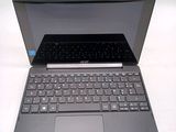 a black laptop with a blue keyboard on a white table