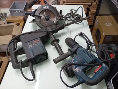 two electric tools sitting on a table in a room