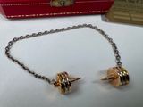 a box with a chain and a pair of earrings on it
