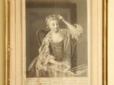 an old picture of a woman sitting in a chair in a room