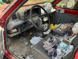 a red car with a bunch of junk in the back