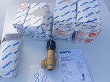 several rolls of toilet paper are sitting on a table next to a water meter
