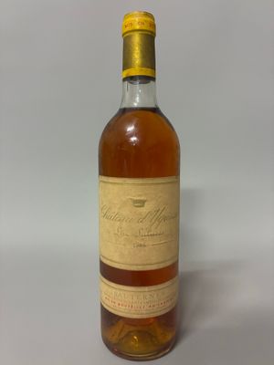 an old bottle of whiskey sitting on a white surface