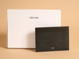 a black card case sitting next to a white box