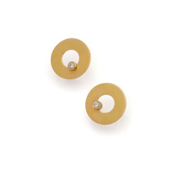 a pair of gold and diamond earrings on a white background