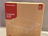la boîte est ouverte pour montrer le contenu d'un barbecue compact