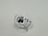 a small glass with a black and white picture on it
