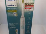 packaging of a philips soniccare electric toothbrush on a white surface