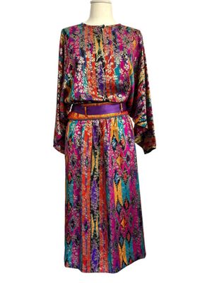 a women ' s colorful dress with a belt on a mannequin mannequin