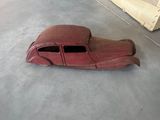 a red toy car that is sitting on the floor