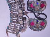two pieces of jewelry that are on a table