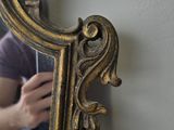 a woman taking a picture of her reflection in a mirror