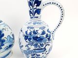 two blue and white vases sitting next to each other