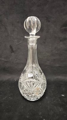 an image of a glass decanter on a black background