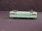 a green toy train on a black background