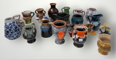 many vases that are lined up together on a table