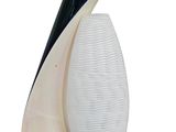 a white and black lamp that is on top of a table