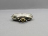 an image of a close up of a silver watch on a table