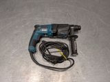 a cord connected to a drill on a metal surface