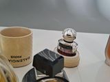 bottles of perfume on a table next to a cup of coffee