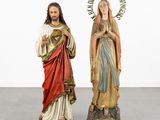 a couple of statues of jesus and mary standing next to each other