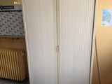 a large white cabinet in the corner of a room
