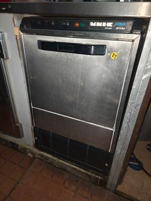 a stainless steel dishwasher in the middle of a kitchen