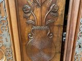 a vase with flowers carved into the side of a door