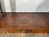 a small wooden box sitting on a tile floor