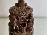 a small statue of a group of people sitting on a table