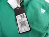a label on a green jacket that says adidas