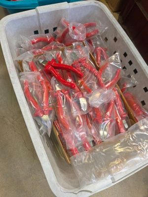 a plastic basket filled with red and white toothbrushes
