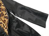 the back of a black leather jacket with a leopard print lining