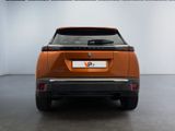 the rear end of an orange electric vehicle parked in a garage