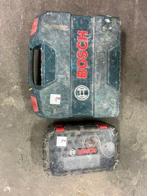 two bosch tools are sitting on the ground next to each other