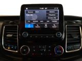 the dashboard of a car with a cell phone in the center