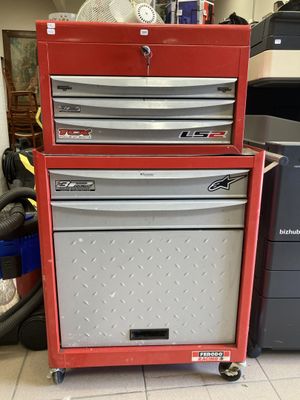 a red tool cabinet with four drawers on top of it