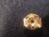 a close up of a gold ring on a black surface