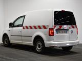 a white van with red stripes parked in a room