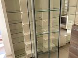 a glass display case in the middle of a room